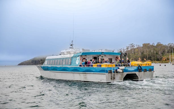 Tourists on the deck of the Stewart Island Ferry in New Zealand waters.