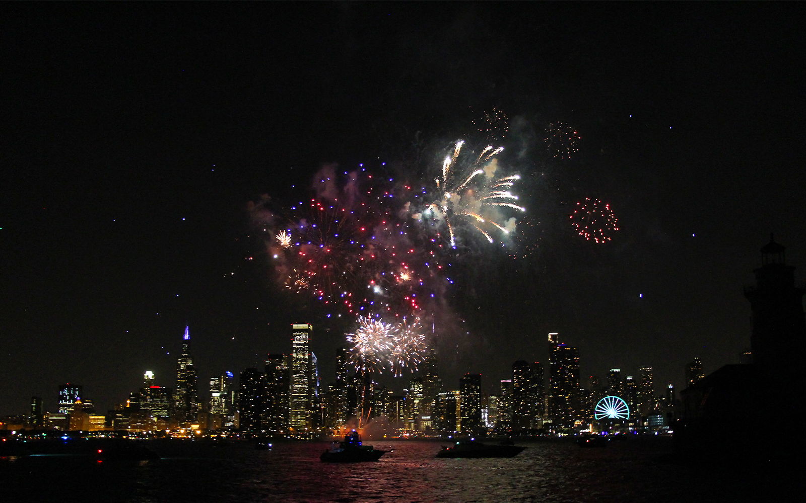 Fireworks over Chicago skyline during dinner cruise on Lake Michigan.
