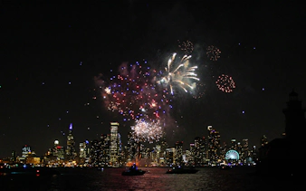 Fireworks over Chicago skyline during dinner cruise on Lake Michigan.