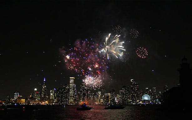 Fireworks over Chicago skyline during dinner cruise on Lake Michigan.