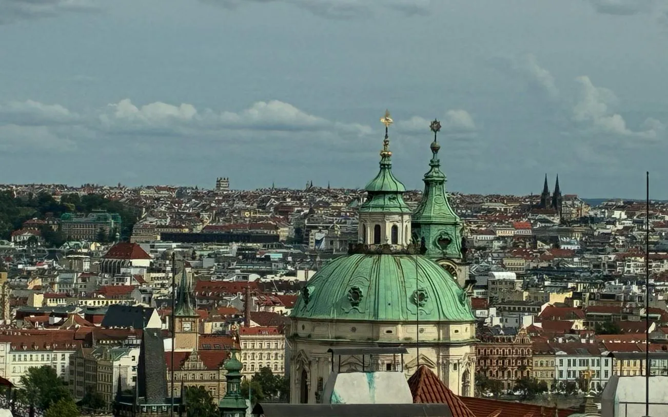 Prague cityscape with St. Nicholas Church dome, part of the Alchemy Mission game.