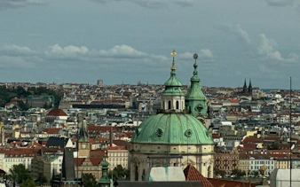 Prague cityscape with St. Nicholas Church dome, part of the Alchemy Mission game.