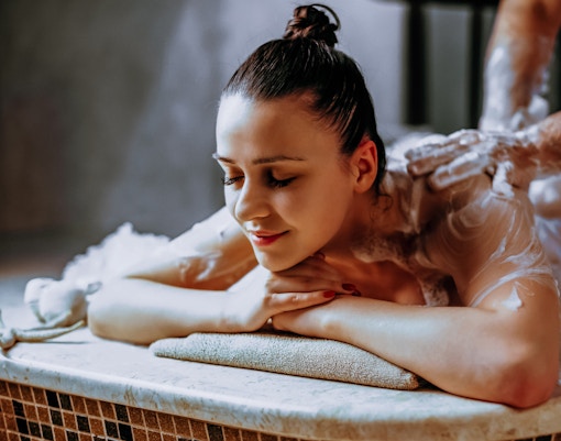 Person receiving a foam massage at Catmamescit Hamam in Beyoglu.