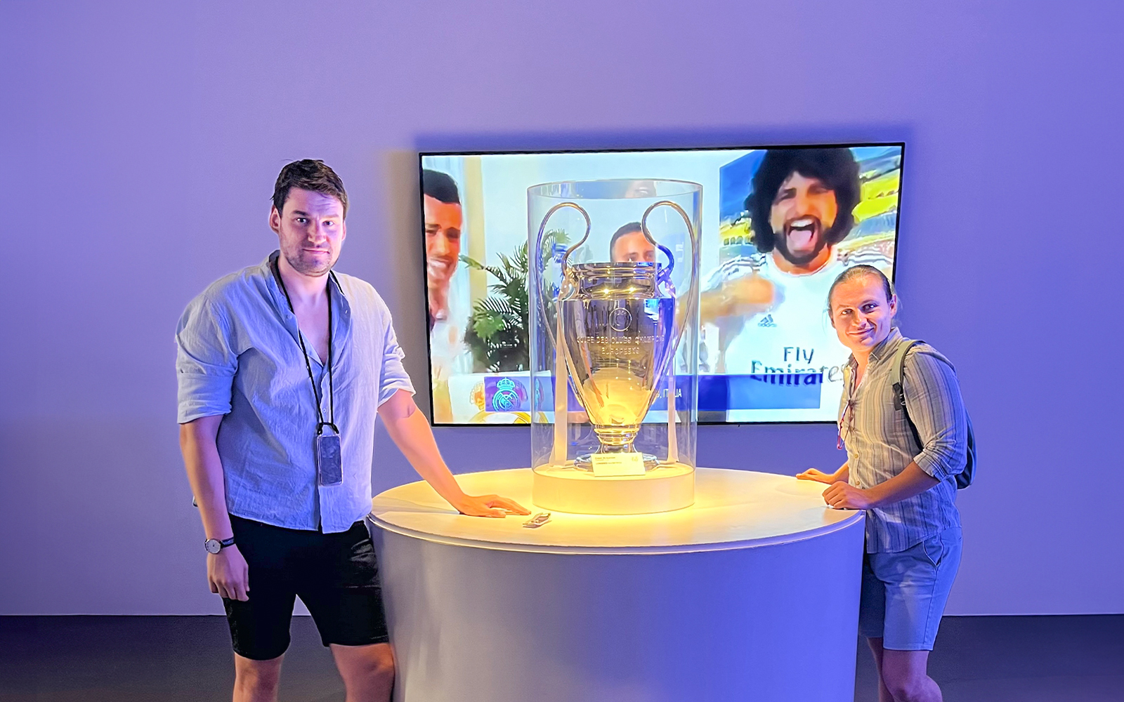 visitors posing with trophy inside santiago bernabeu stadium