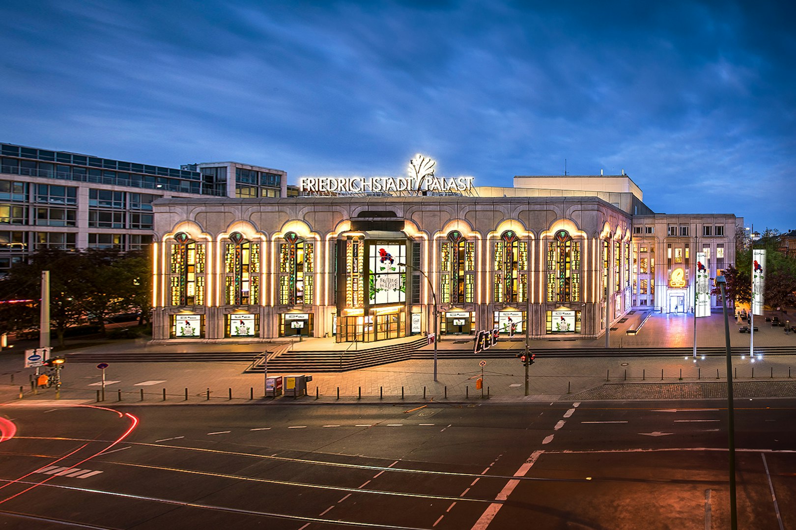 Friedrichstadt Palast illuminated at night, Berlin, showcasing FALLING | IN LOVE Grand Show.