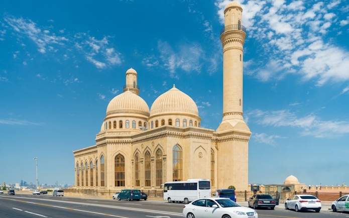 Bibi-Heybat Mosque with domes and minaret under blue sky, Baku, Azerbaijan.
