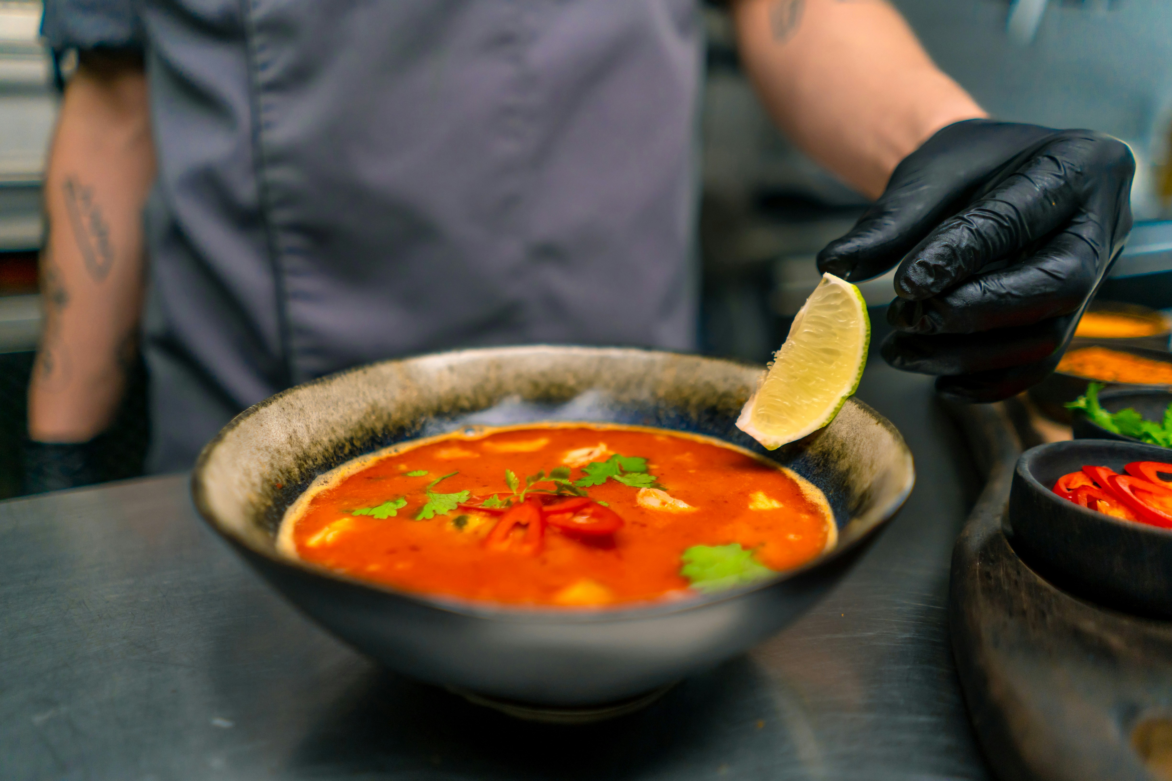 Seafood soup with lime served in an Asian restaurant setting.