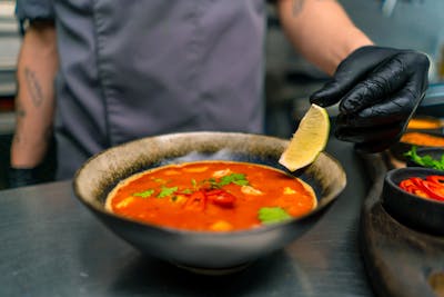 Soup with seafood and lime in asian restaurant