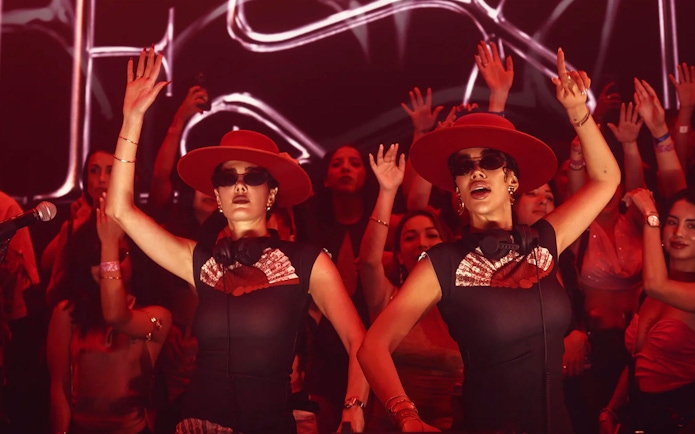 DJs performing at Mestiza event in Ibiza nightclub with crowd dancing.