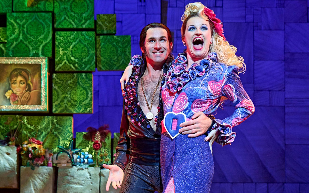 Performers in colorful costumes on stage during Matilda The Musical.