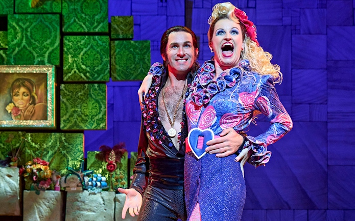 Performers in colorful costumes on stage during Matilda The Musical.