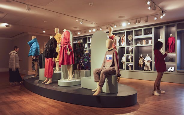 Mannequins displaying fashion designs at Porto Fashion and Fabric Museum exhibit.