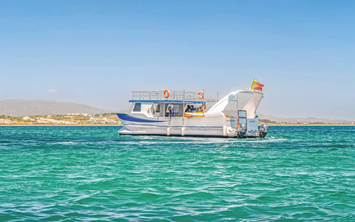 Catamaran on dolphin and Benagil caves tour in Algarve, Portugal.