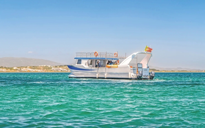 Catamaran on dolphin and Benagil caves tour in Algarve, Portugal.
