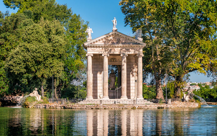 Borghese Gallery temple surrounded by trees and water in Rome.
