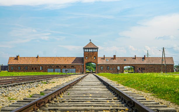Train tracks leading to the entrance of Auschwitz concentration camp in Poland.