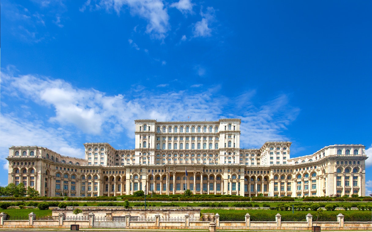 Palace of the Parliament in Bucharest, Romania, with clear blue sky.