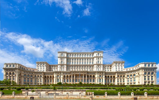 Palace of the Parliament in Bucharest, Romania, with clear blue sky.