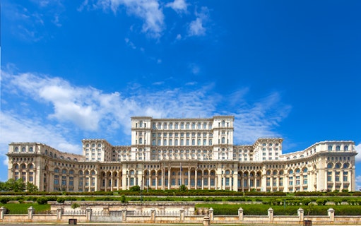 Palace of the Parliament in Bucharest, Romania, with clear blue sky.