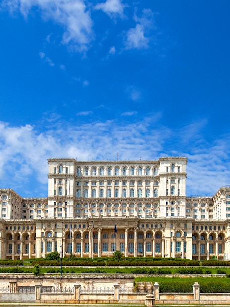 Palace of the Parliament in Bucharest, Romania, with clear blue sky.