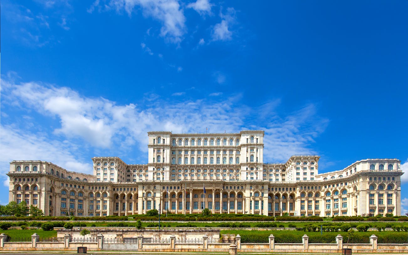 Palace of the Parliament in Bucharest, Romania, with clear blue sky.