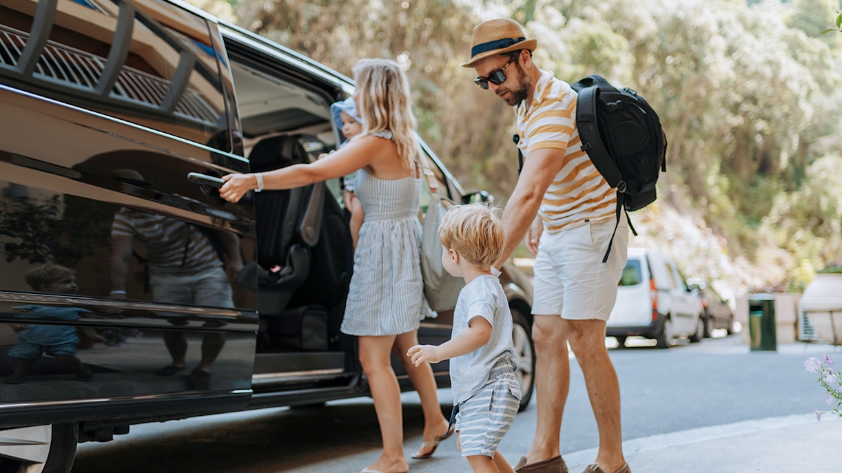 Tourists boarding an AC car for Lake Bled, Postojna Cave, and Predjama Castle tour from Ljubljana.