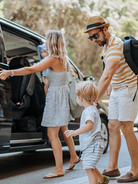 Tourists boarding an AC car for Lake Bled, Postojna Cave, and Predjama Castle tour from Ljubljana.