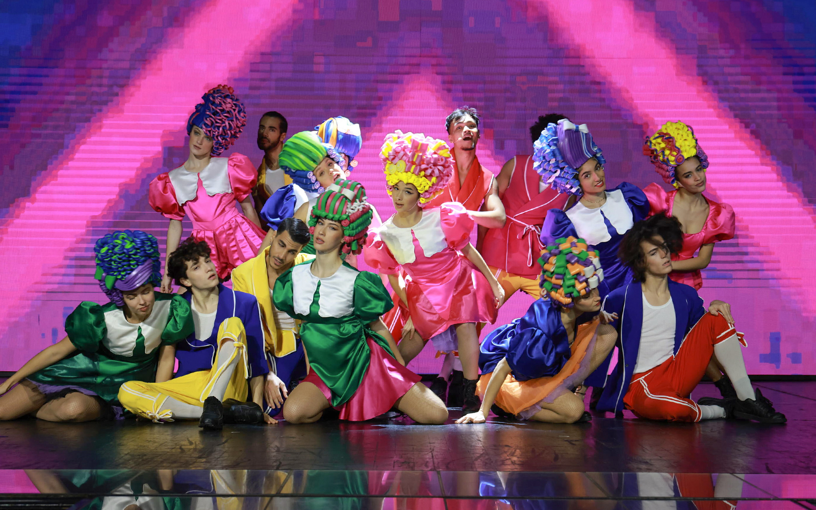 Performers on stage at Paradis Latin, Paris, showcasing vibrant costumes and dynamic choreography.