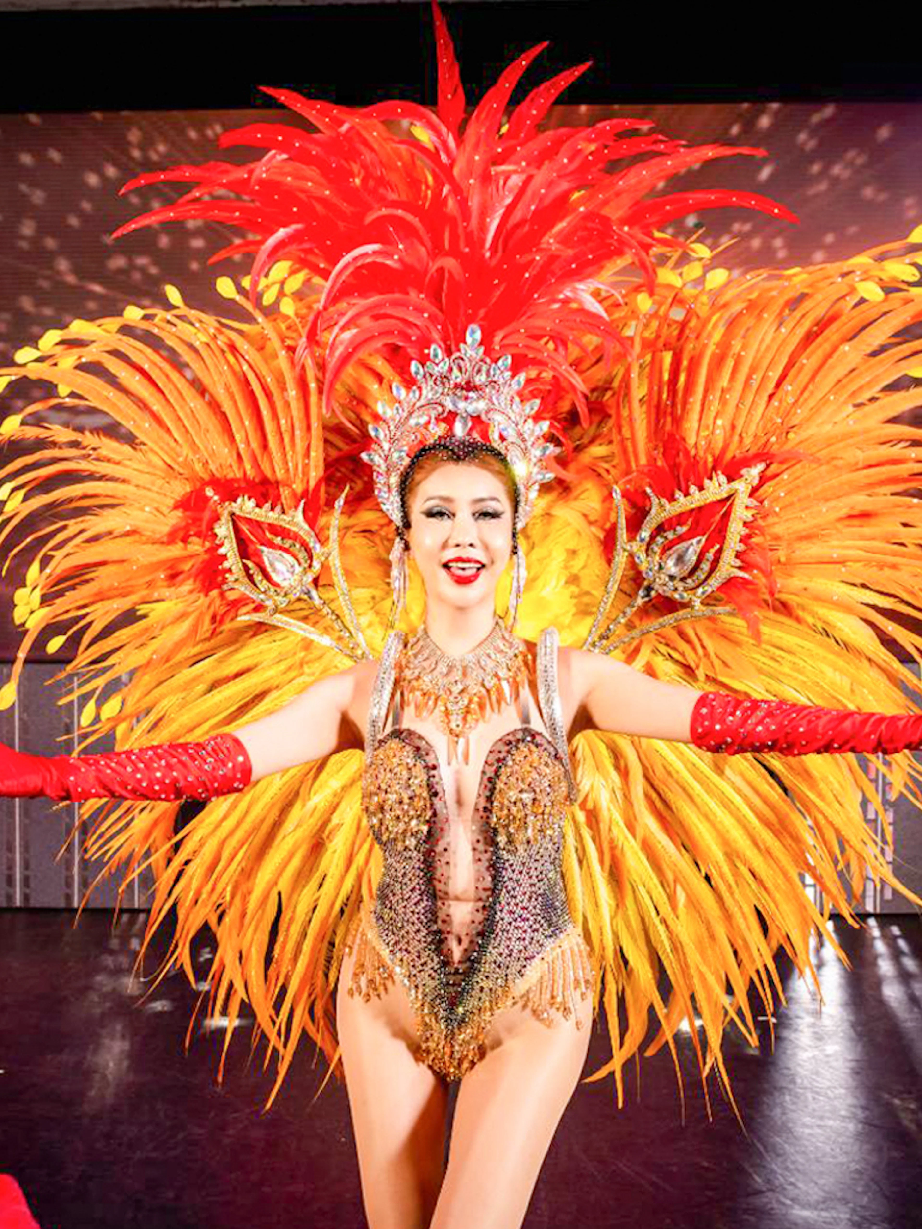 Performer in vibrant costume at Simon Cabaret Show, Phuket.