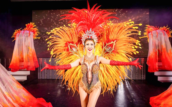 Performer in vibrant costume at Simon Cabaret Show, Phuket.