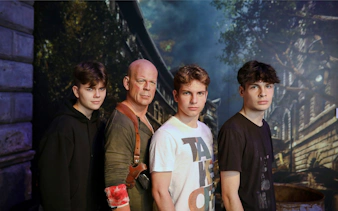 Wax figure of an action movie character with visitors at Madame Tussauds, Budapest.
