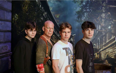 Wax figure of an action movie character with visitors at Madame Tussauds, Budapest.