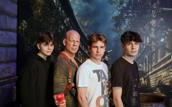 Wax figure of an action movie character with visitors at Madame Tussauds, Budapest.