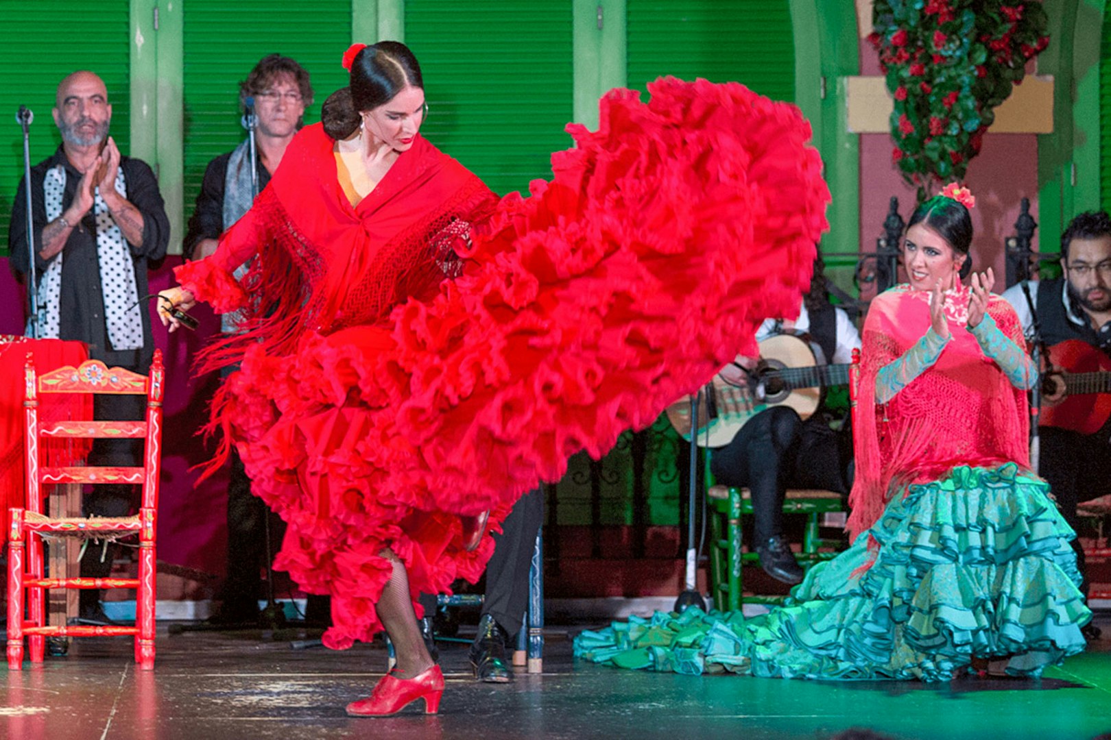 Flamenco dancer in red dress performing at Only Flamenco, Seville.