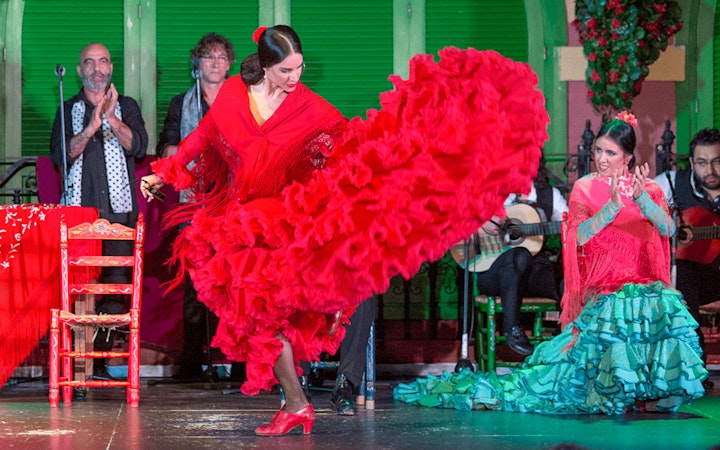 Flamenco dancer in red dress performing at Only Flamenco, Seville.