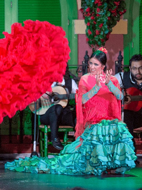 Flamenco dancer in red dress performing at Only Flamenco, Seville.