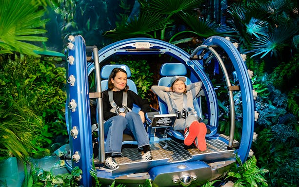 Visitors enjoying a Jurassic World ride experience in London.