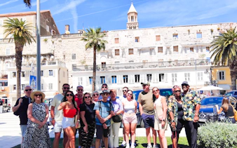 Tour group in front of Diocletian's Palace, Split, during panoramic sightseeing bus and guided walking tour.