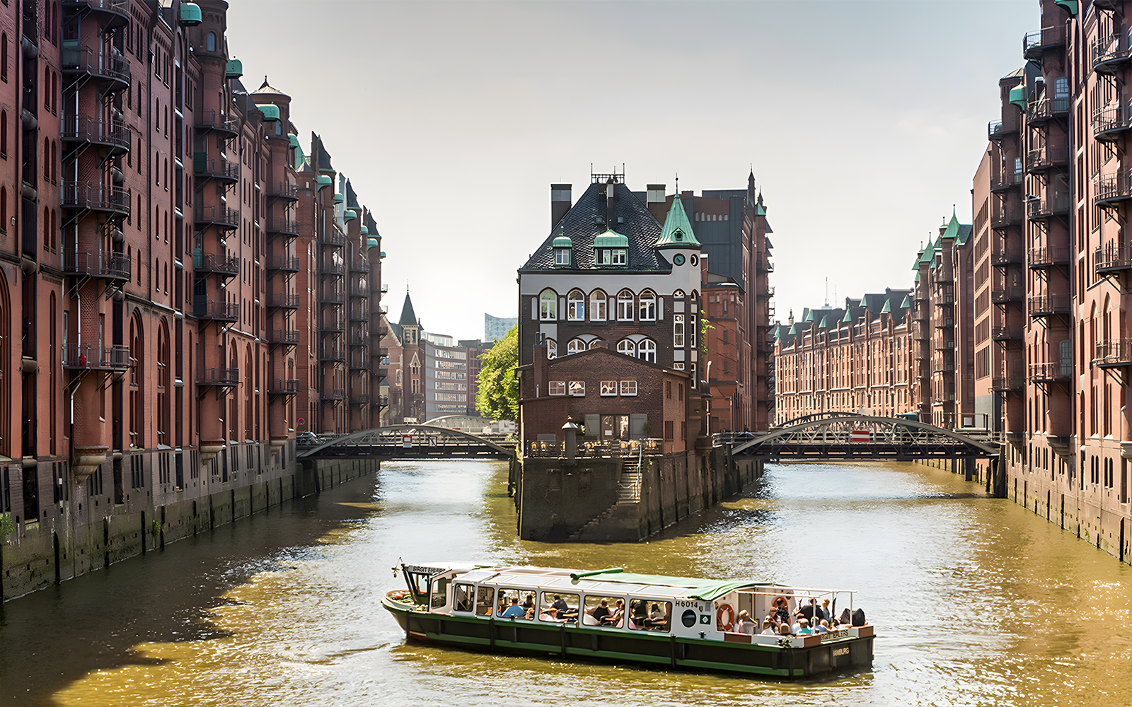 Boat tour through Hamburg's Speicherstadt with historic brick warehouses.