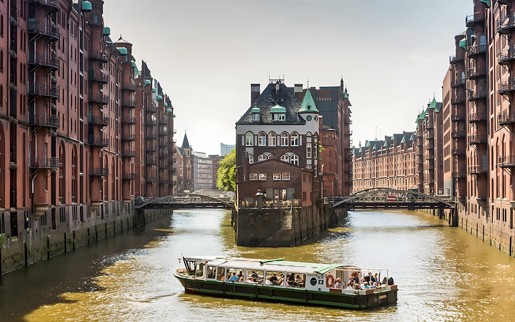 Boat tour through Hamburg's Speicherstadt with historic brick warehouses.