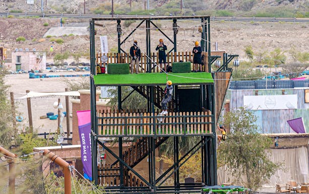 Zipline platform at Hatta Wadi Hub with participants preparing for adrenaline activities.