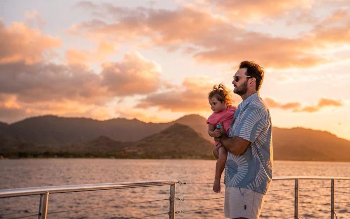 Father and child enjoying sunset views on West Oahu Signature Sunset Sail.