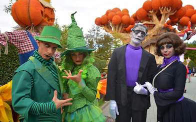 Costumed performers at Gardaland Halloween event with themed decorations.