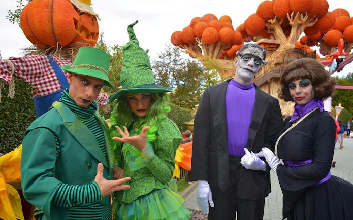 Costumed performers at Gardaland Halloween event with themed decorations.