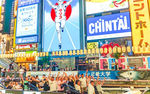 Colourful billboards along Dotonbori River in Osaka, viewed from a river cruise.