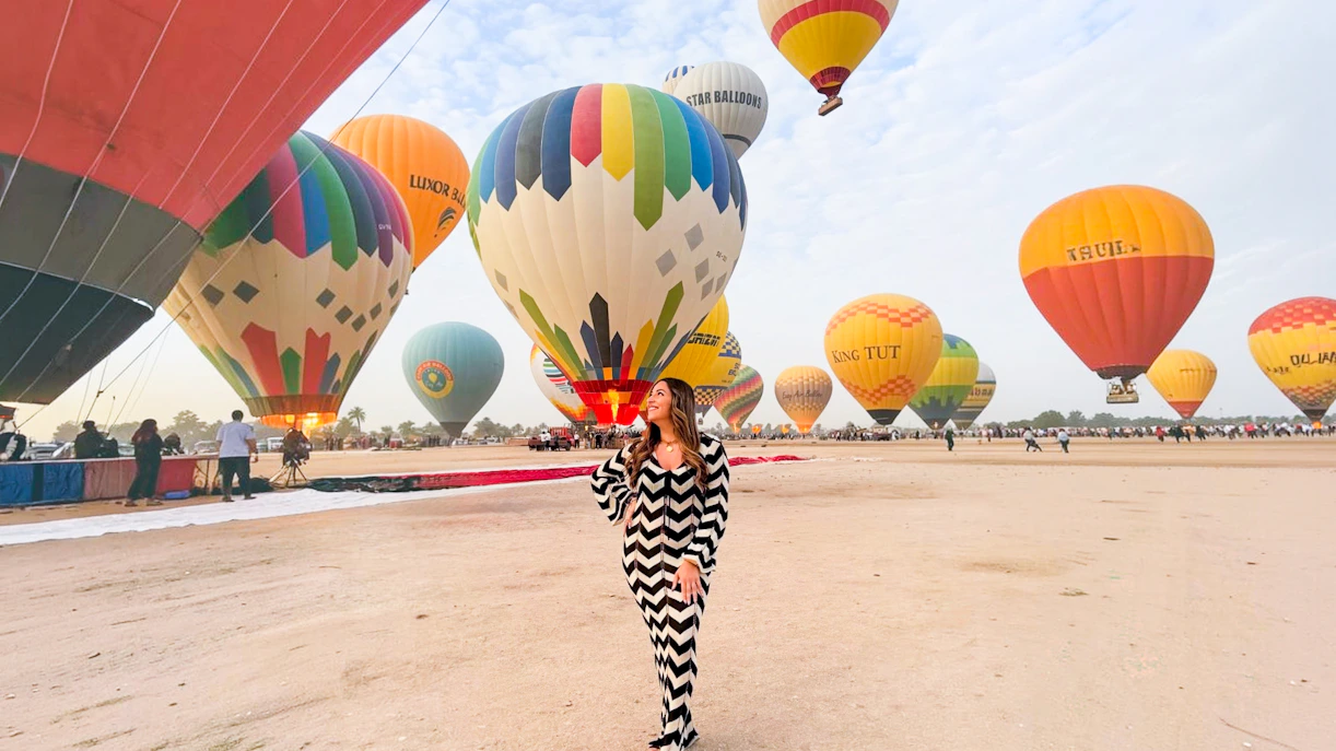 Hot air balloons preparing for flight in Luxor desert.