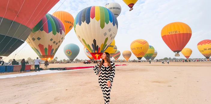 Hot air balloons preparing for flight in Luxor desert.