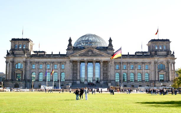 Reichstag building in Berlin with visitors on the lawn during a 3-hour private guided tour.