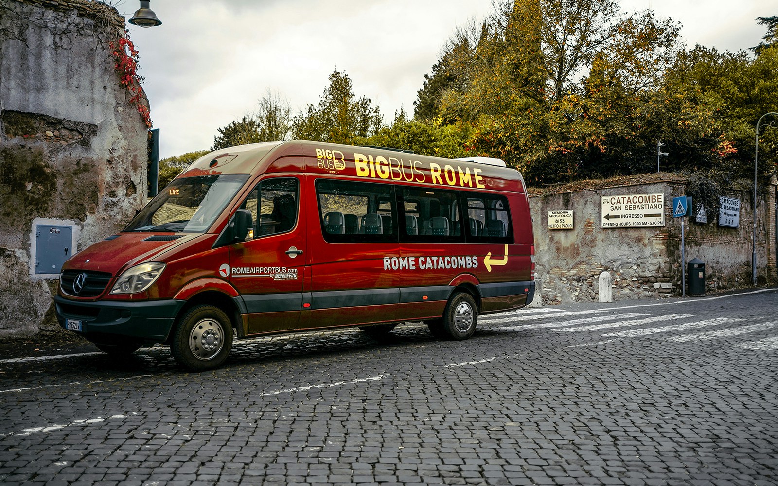 Big Bus tour on Appian Way, Rome, passing ancient catacombs and historical landmarks.