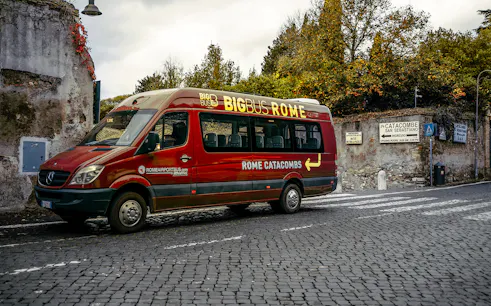 Big Bus Rome parked near Catacombe San Sebastiano entrance on Appian Way.